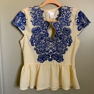 Esley Collection peplum top with royal blue stitched design